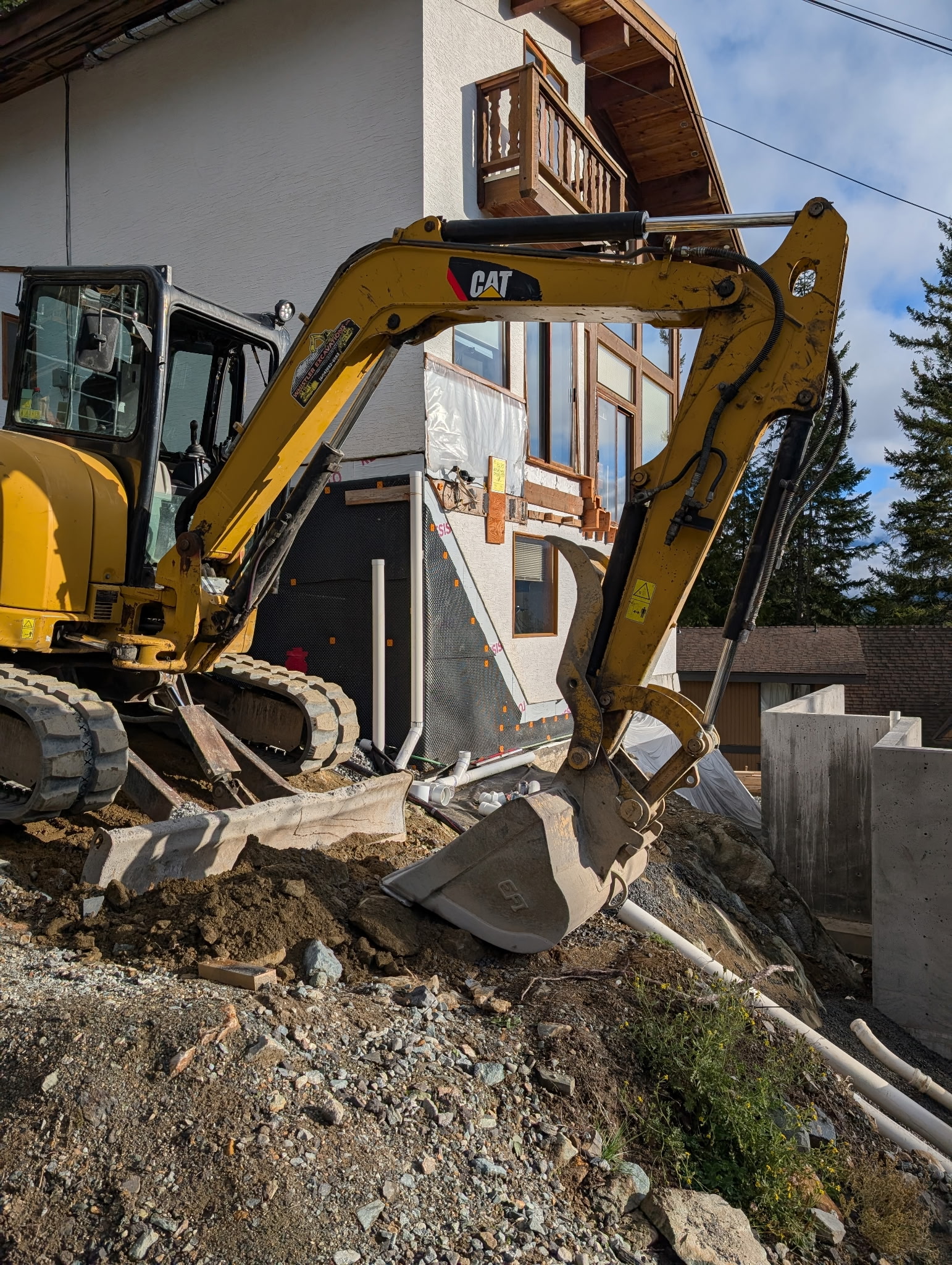 CAT mini excavator residential site servicing pipe work Whistler